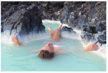 Picture of a woman relaxing at a natural hot spring.